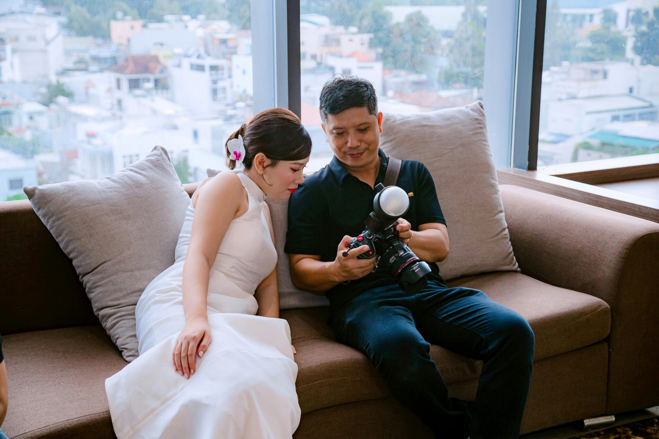 Experienced professional wedding photographer preparing camera for shoot.